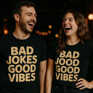 Person wearing the black comedy t shirt graphic tee - "Bad Jokes Good Vibes" design