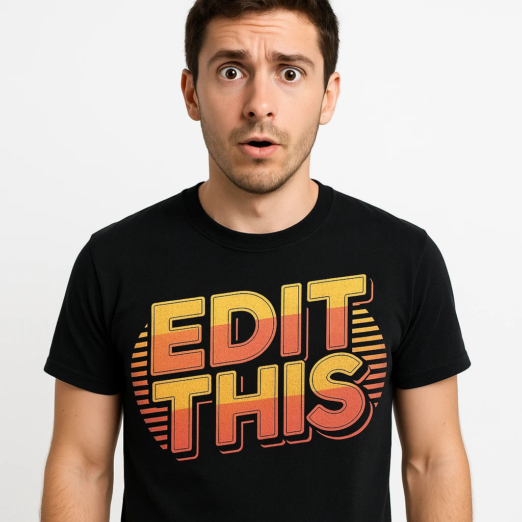 Close-up of the "Edit This" orange print on a premium Bella+Canvas black journalist t shirt