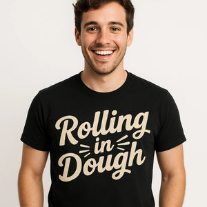 Close-up of the "Rolling in Dough" beige print on a premium Bella+Canvas black baker shirts