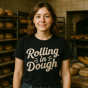Lifestyle shot of the "Rolling in Dough" black baker shirts in a real-world setting
