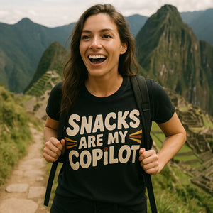 "Snacks Are My Copilot" black adventure t shirt, photographed as gifts for adventure lovers