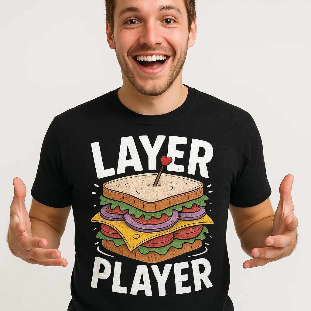 Close-up of the "Layer Player" gold print on a premium Bella+Canvas black sandwich shirts