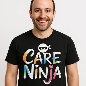 Close-up of the "Care Ninja" white print on a premium Bella+Canvas black social worker shirts