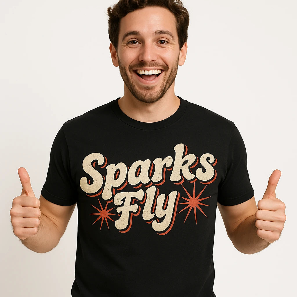 Close-up of the "Sparks Fly" beige print on a premium Bella+Canvas black new years eve shirts for women