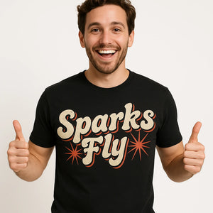 Close-up of the "Sparks Fly" beige print on a premium Bella+Canvas black new years eve shirts for women