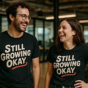 Person wearing the black growth mindset t shirt graphic tee - "Still Growing Okay" design