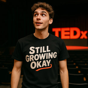 Lifestyle shot of the "Still Growing Okay" black growth mindset t shirt in a real-world setting
