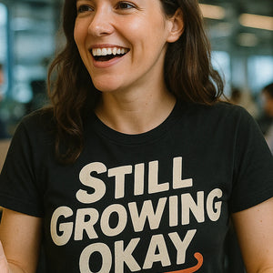 "Still Growing Okay" black growth mindset t shirt, photographed as growth mindset lover gift