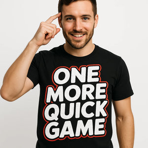 Close-up of the "One More Quick Game" white print on a premium Bella+Canvas black board game t shirt