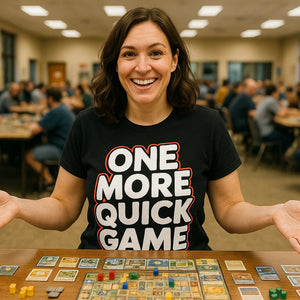 Lifestyle shot of the "One More Quick Game" black board game t shirt in a real-world setting