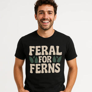 Close-up of the "Feral for Ferns" light gray print on a premium Bella+Canvas black nature walk t shirt