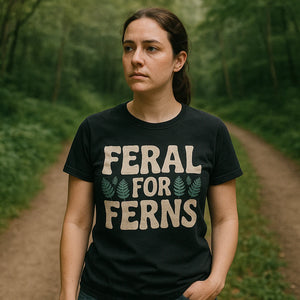 Lifestyle shot of the "Feral for Ferns" black nature walk t shirt in a real-world setting