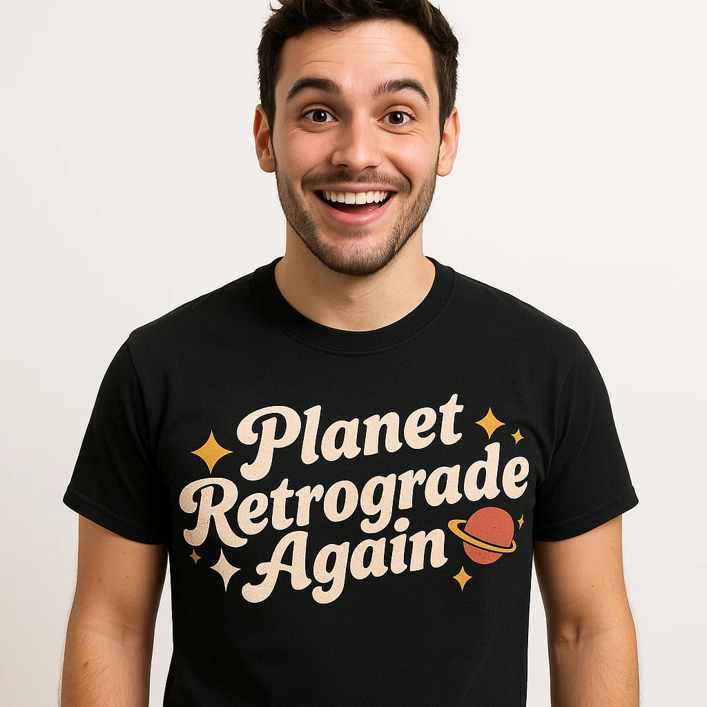 Close-up of the "Planet Retrograde Again" cream print on a premium Bella+Canvas black astrology shirts