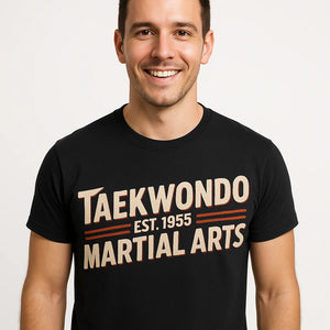 Close-up of the "Taekwondo Est 1955 Martial Arts" beige print on a premium Bella+Canvas black martial arts tee shirts