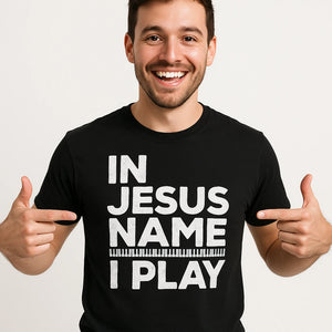 Close-up of the "In Jesus Name I Play" white print on a premium Bella+Canvas black piano shirts