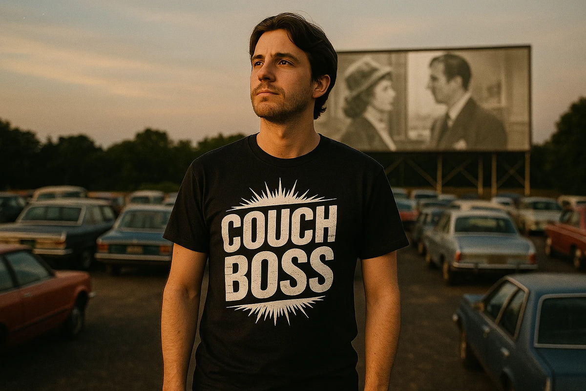 Lifestyle shot of the "Couch Boss" black graphic tee in a real-world setting