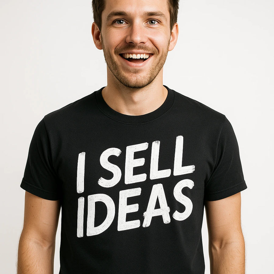 A smiling person wearing a black t-shirt with bold white text. The background is plain white.