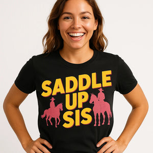 Close-up of the "Saddle Up Sis" yellow print on a premium Bella+Canvas black shirts for horseback riding
