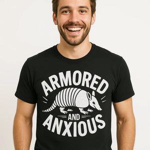 Close-up of the "Armored and Anxious" white print on a premium Bella+Canvas black armadillo t shirt