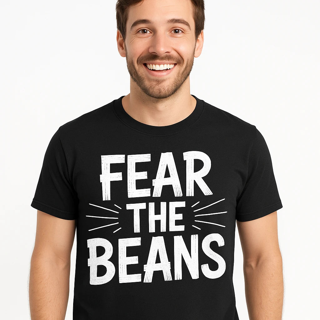 A person with short brown hair and a beard is smiling while wearing a black T-shirt with bold white text. The shirt reads "FEAR THE BEANS" in large capital letters. The background is plain white.