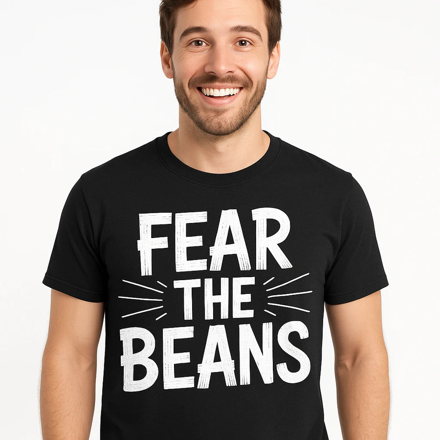 A person with short brown hair and a beard is smiling while wearing a black T-shirt with bold white text. The shirt reads "FEAR THE BEANS" in large capital letters. The background is plain white.
